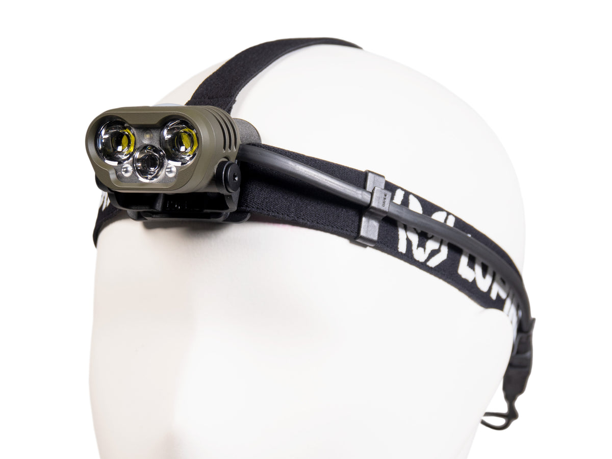 Blika Professional headlamp in O.D. Green on the headband, side view with cable routing