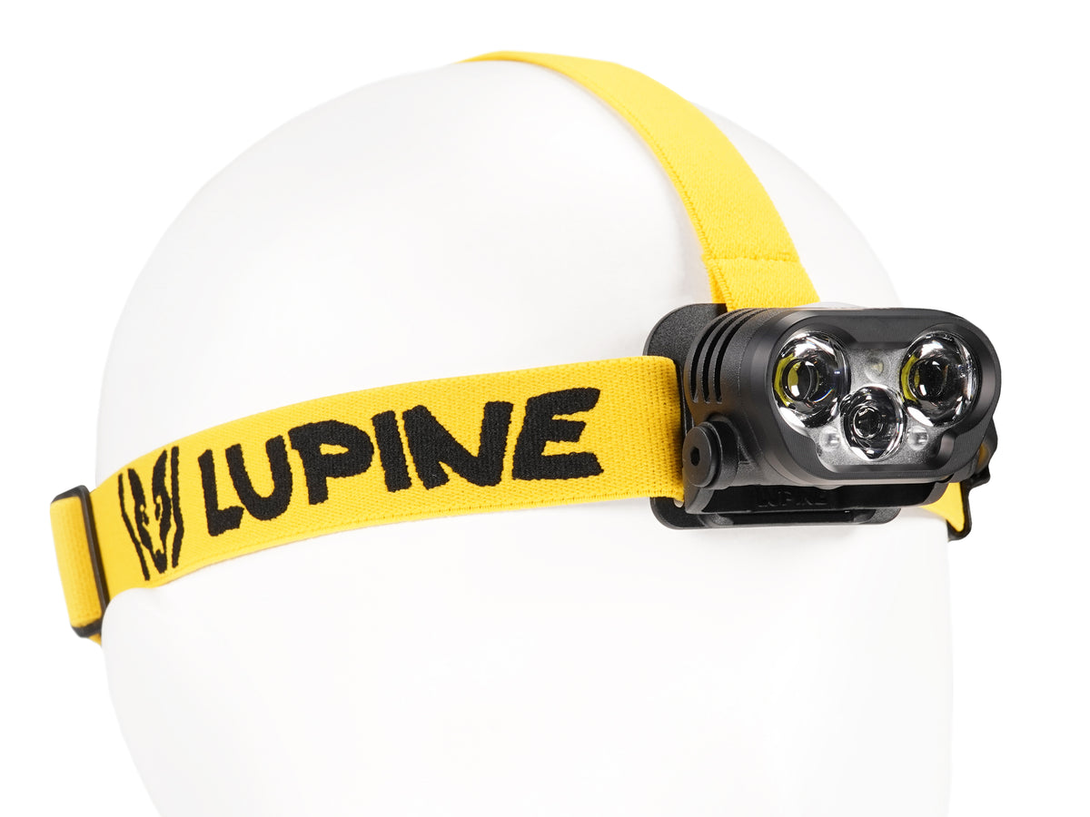 Blika headlamp on the yellow-black headband, front three-quarter view