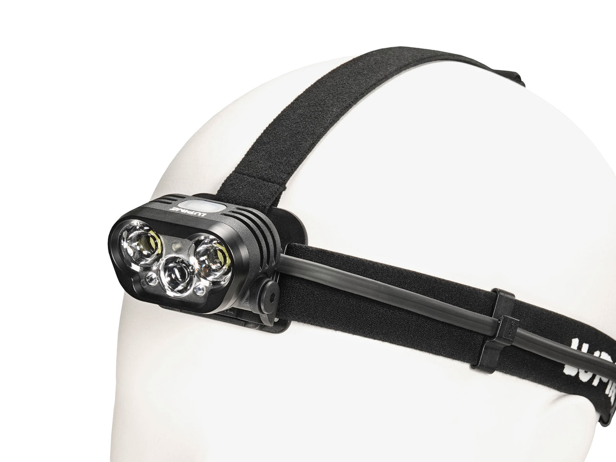 Blika headlamp on the black headband, side view with cable routing