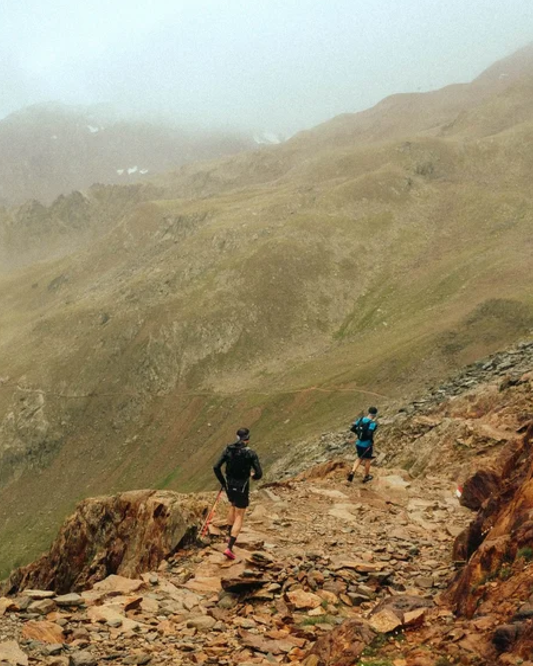Hiker on a mountain ridge at dusk with Lupine light