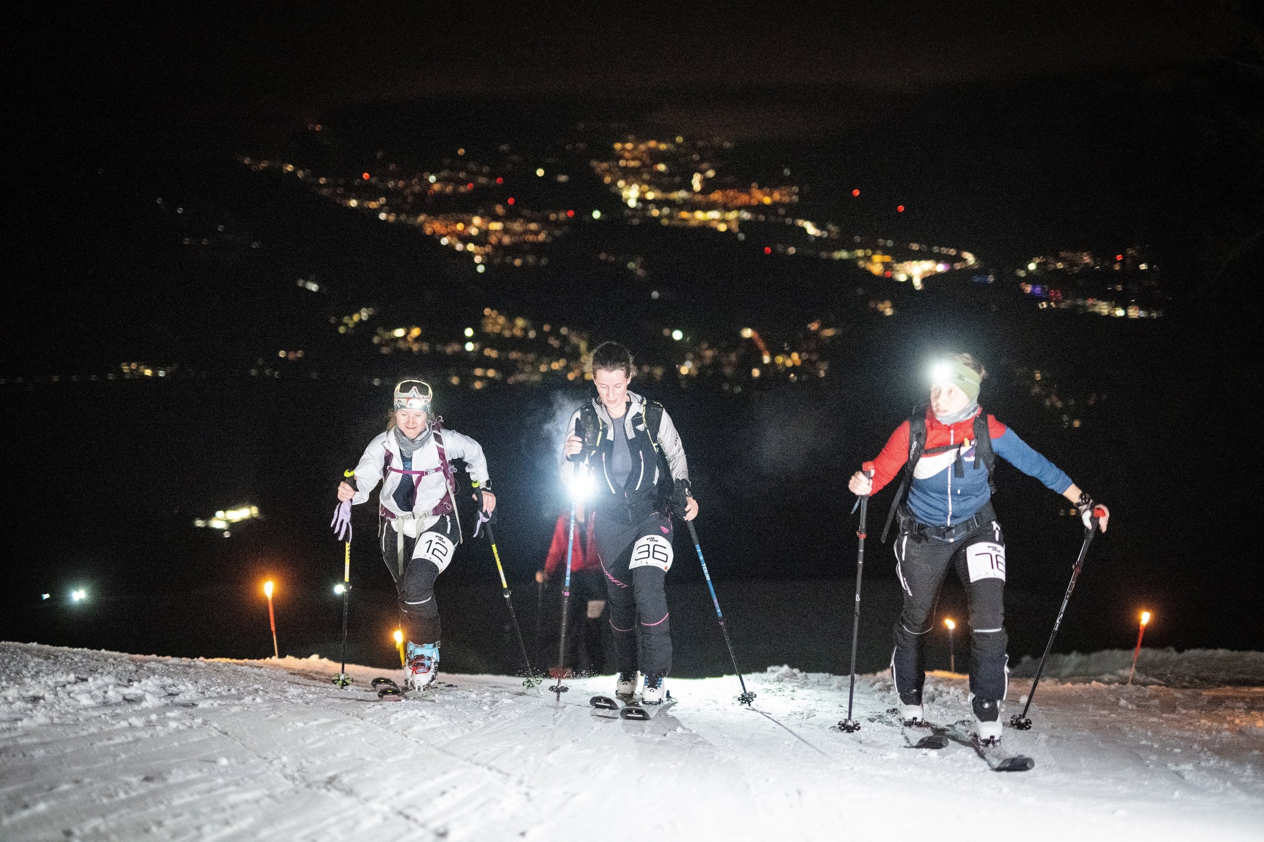 Three cyclists at night with bright Lupine front lights