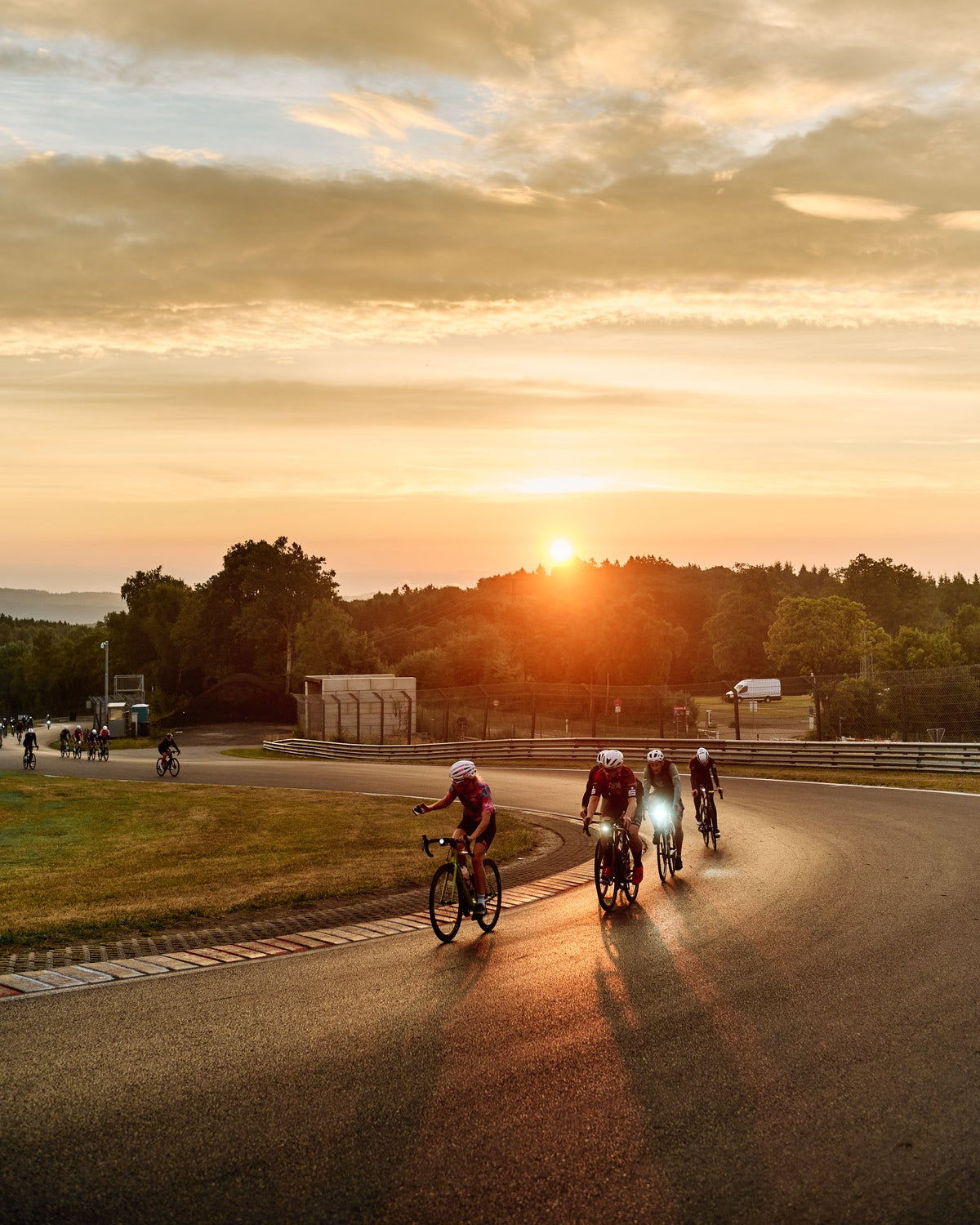 Road cyclists at sunrise with Lupine front lights on the Nordschleife (Rad am Ring)